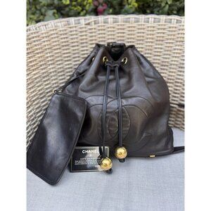 Authentic CHANEL black lambskin CC drawstring backpack with removable pouch